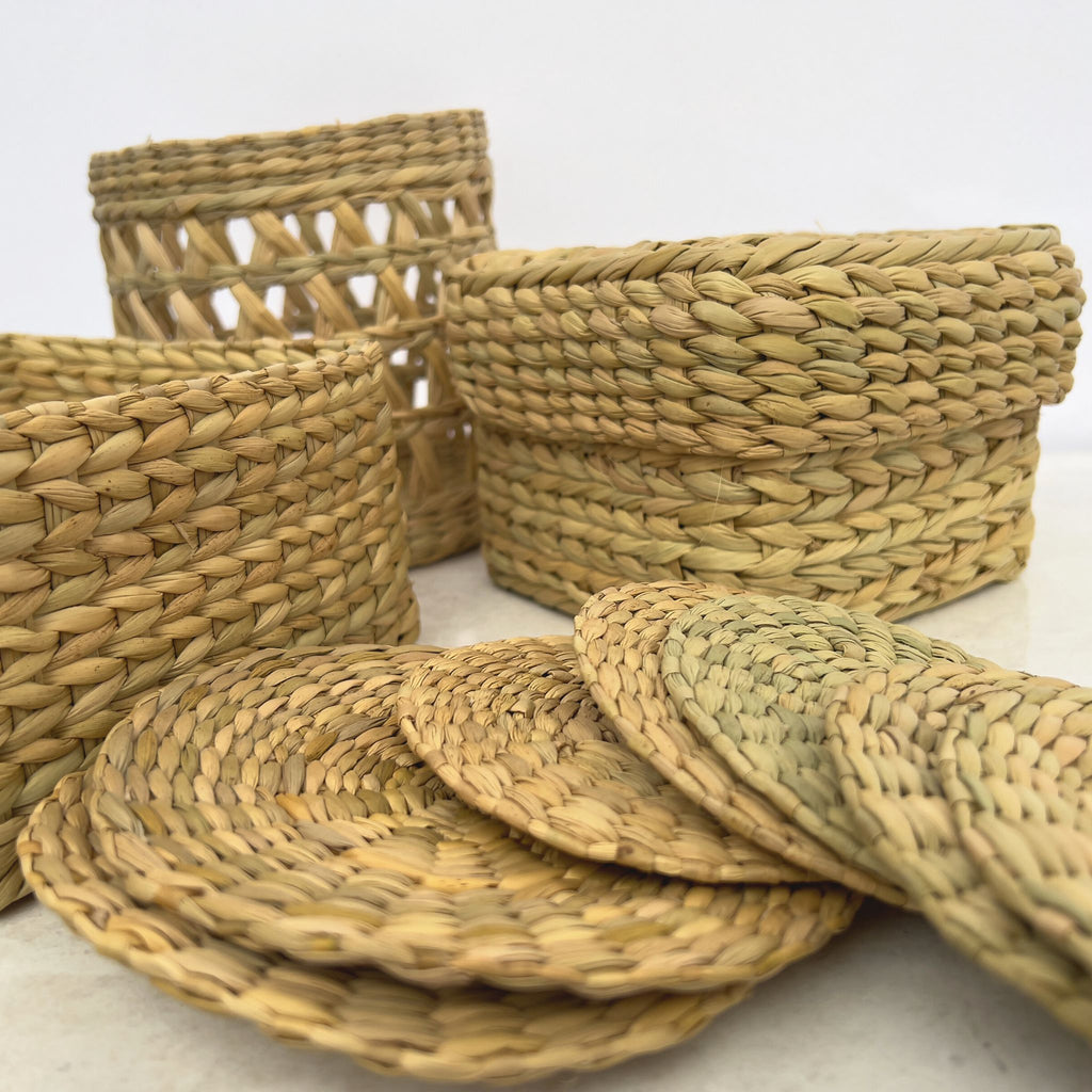 Grouping of traditional weaving from northeastern India. Open weave basket, box, box with lid, and coasters.