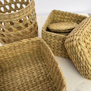 Grouping of traditional weaving from northeastern India. Open weave basket, box, box with lid, and coasters.