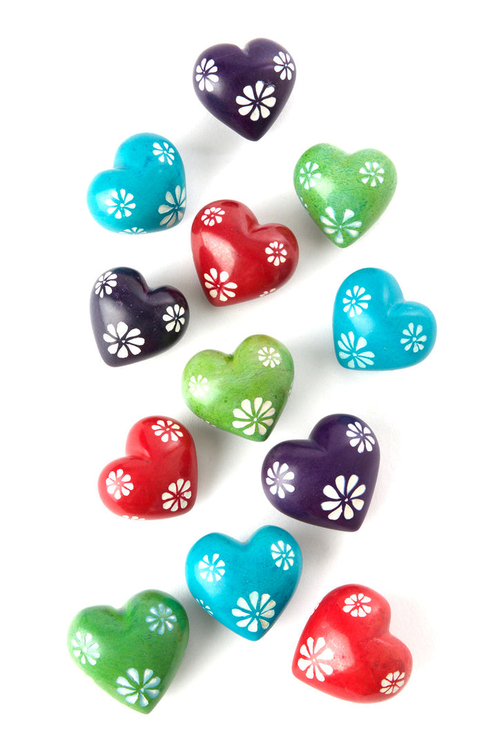 Collection of Colourful tiny rainbow colored soapstone hearts with white etched flowers