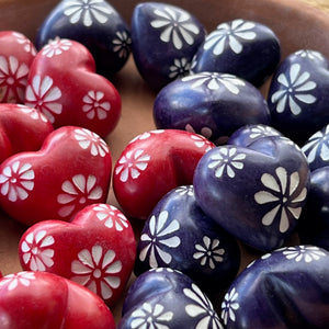 Collection of Colourful tiny rainbow colored soapstone hearts with white etched flowers, red and purple hearts.
