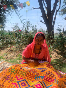 Sushila embroidering a gudri blanket